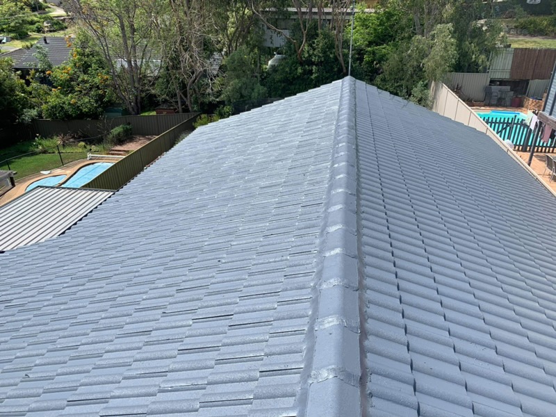The same roof after the ridges were re-bedded and re-pointed and the tiles repainted in slate grey