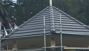 Roof restoration in progress on a tiled roof