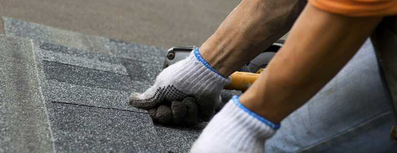 employee intalling roof tiles