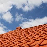 a tiled roof with cloudy sky view