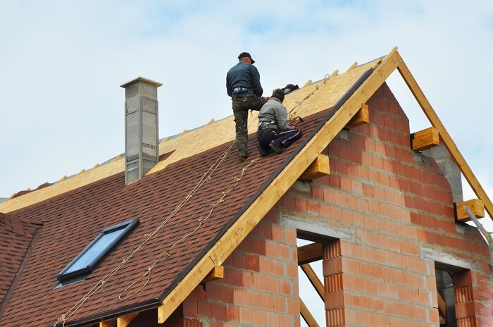 Two men installing a roof