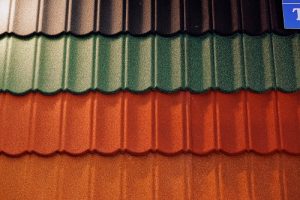 Selection of different roof tiles, including brown, red and green tiles
